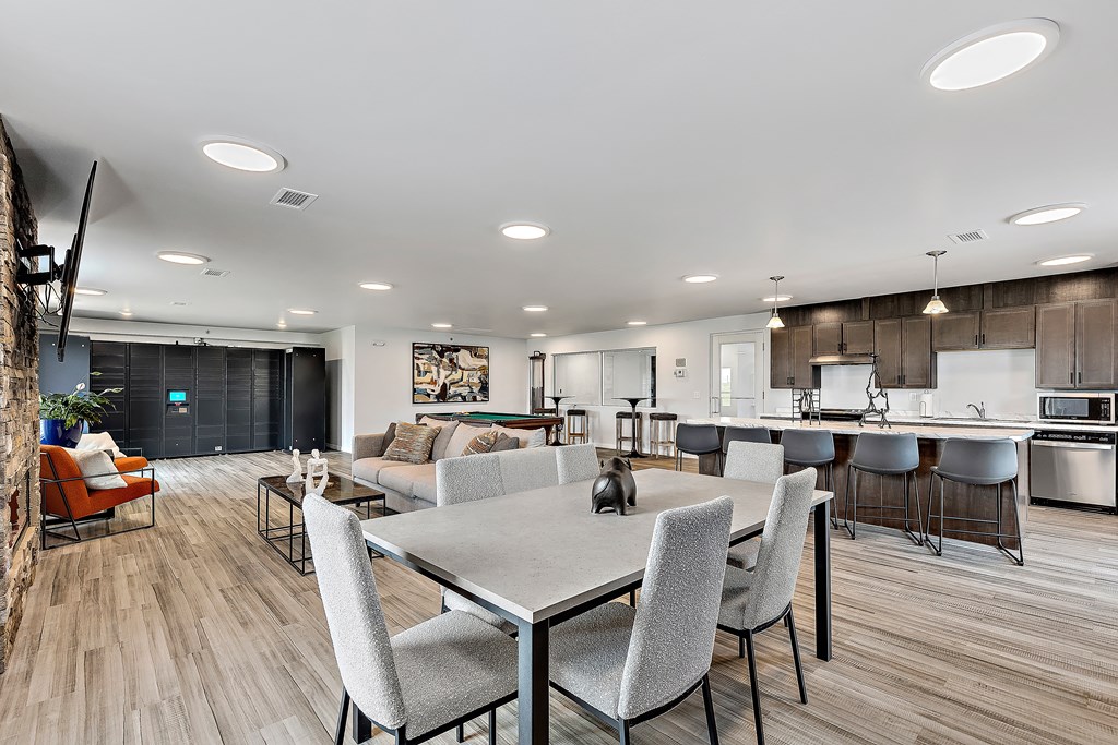 a living room and kitchen area with a dining table and chairs