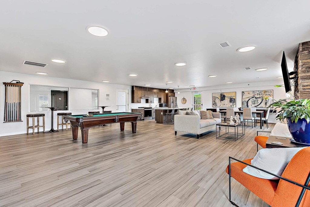 A living room with a pool table and a couch. at Red Rock Apartments, Rapid City, SD