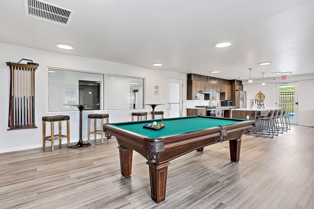 a recreation room with a pool table and bar at Red Rock Apartments, Rapid City, South Dakota