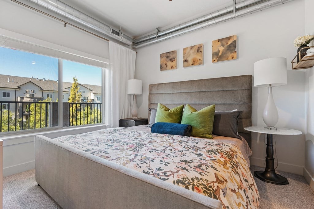 a bedroom with a large bed and a large window at The Revival, Utah
