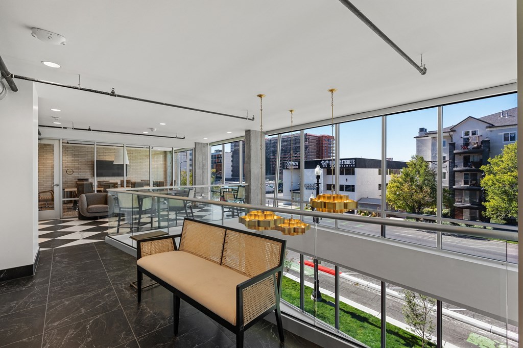 a view of a living room from a balcony with glass railing at The Revival, Salt Lake City, 84101