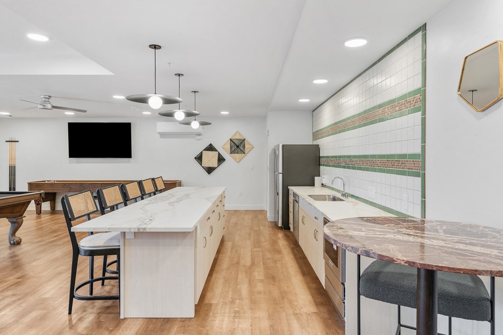 a kitchen and dining area with a marble counter top and a table with chairs at The Revival, Utah