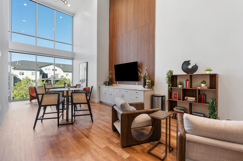 a living room and dining room with a table and chairs and a large window at The Revival, Salt Lake City, Utah