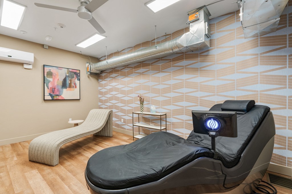 a spa room with a massage bed and a massage chair at The Revival, Salt Lake City, Utah