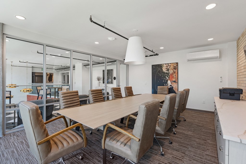 a conference room with a long wooden table and chairs at The Revival, Salt Lake City, 84101