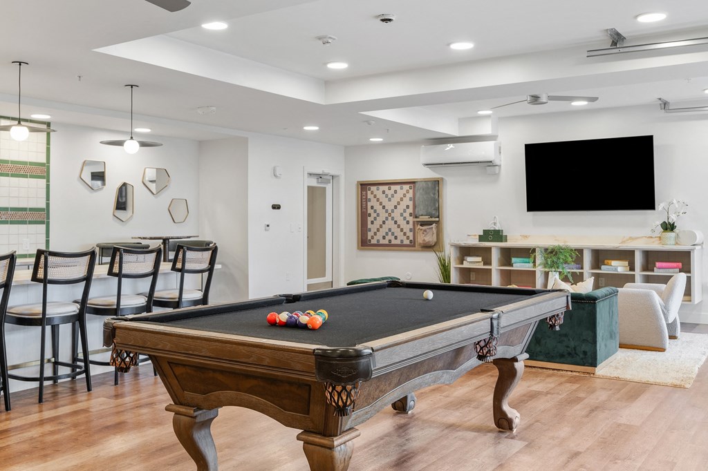 a game room with a pool table and a tv at The Revival, Salt Lake City, UT