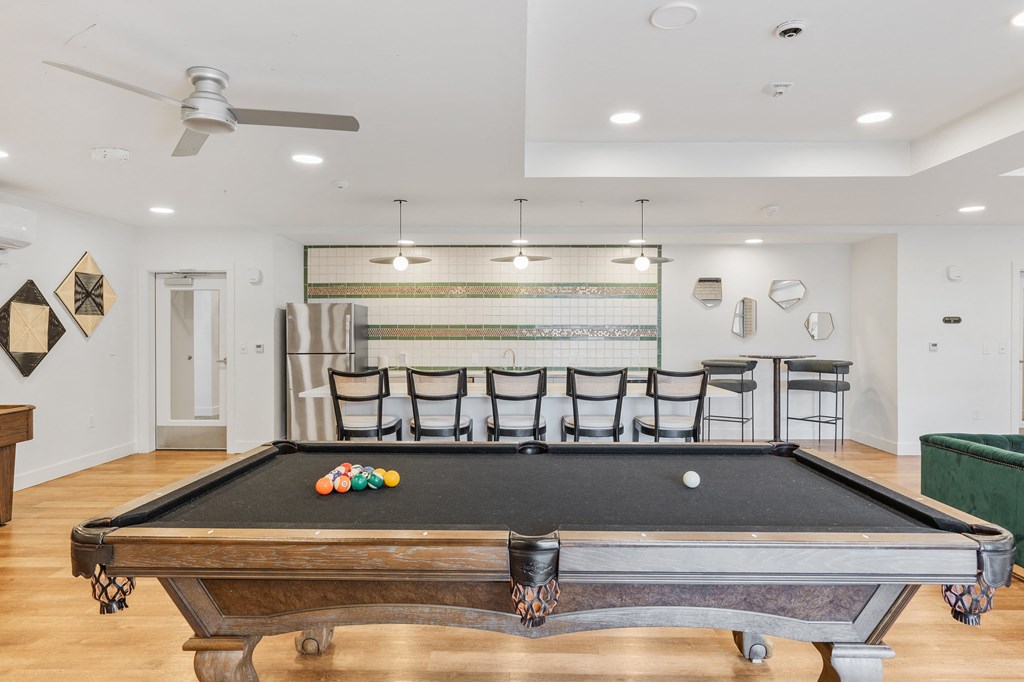the pool table in the living room of a house with a bar and a bill at The Revival, Salt Lake City, Utah
