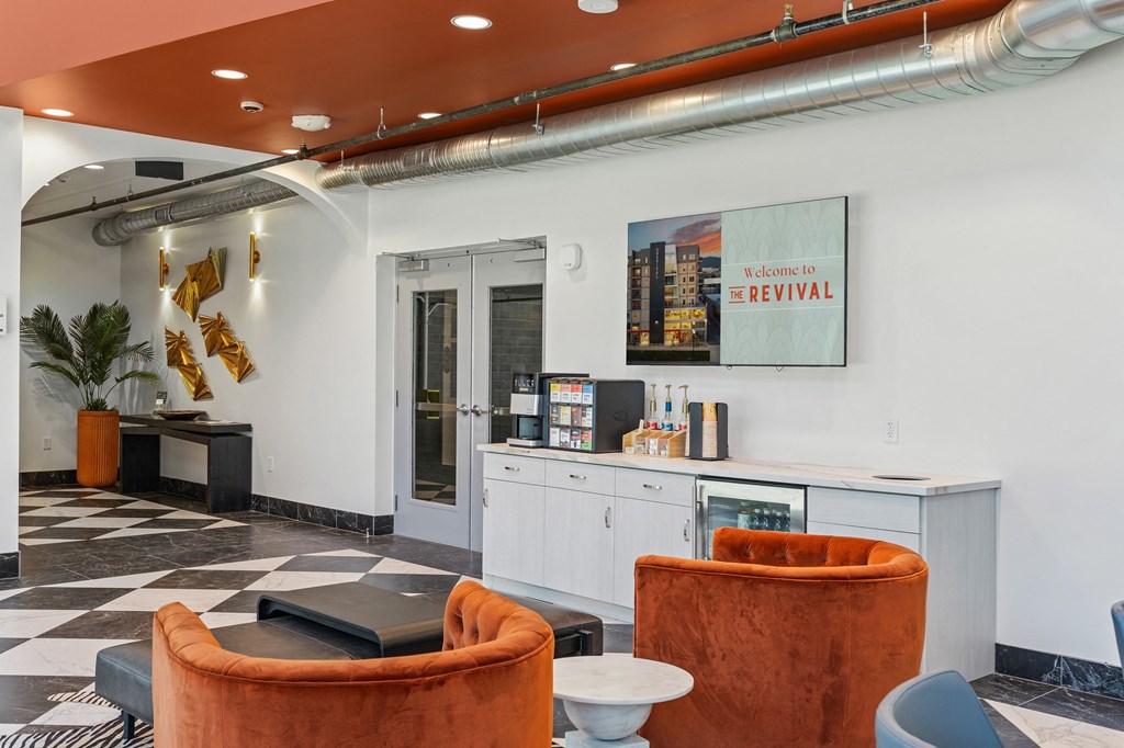 a lobby with couches and chairs and a counter with a drink fountain at The Revival, Salt Lake City, 84101
