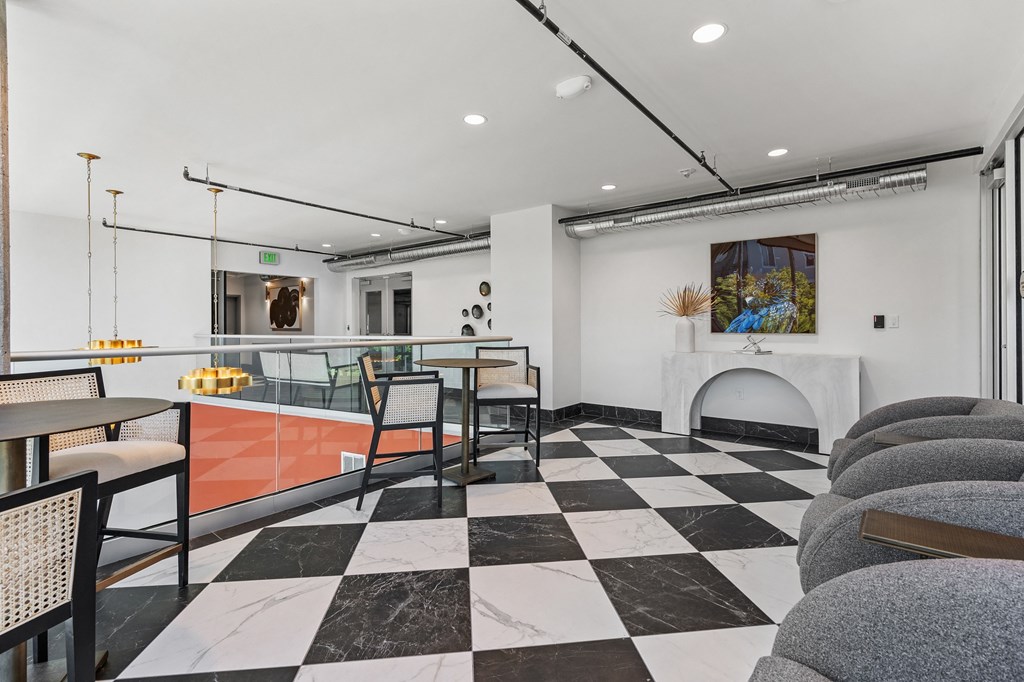 a lounge area with tables and chairs and a fireplace at The Revival, Utah