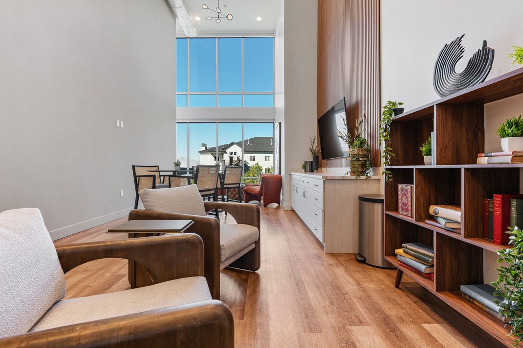 a living room filled with furniture and a large window at The Revival, Salt Lake City, 84101