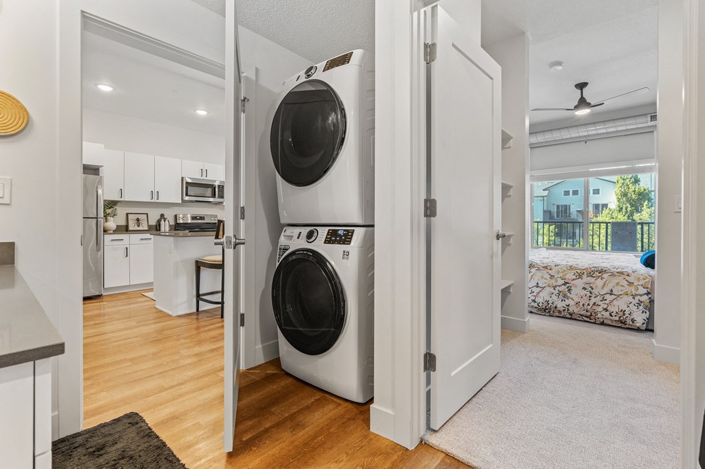 a white laundry room with a washer and dryer in it at The Revival, Salt Lake City