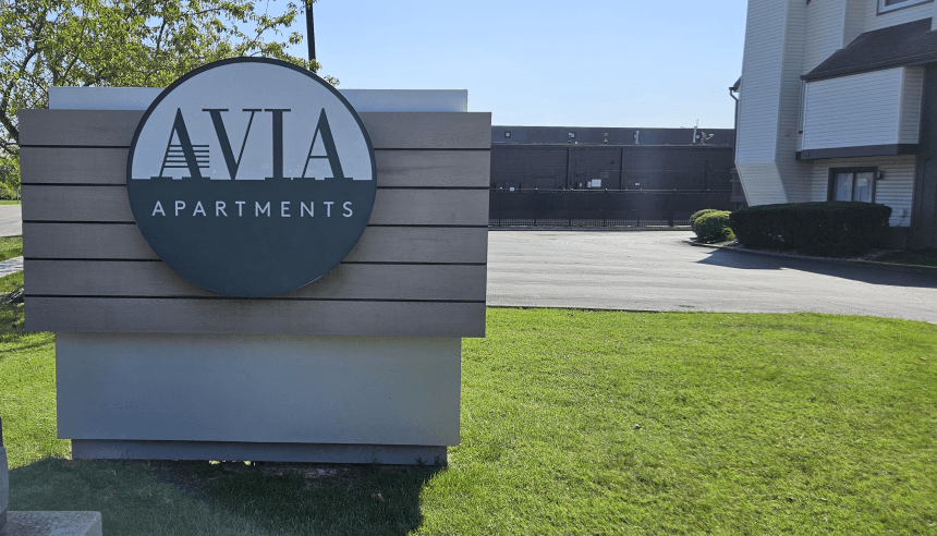 apartments sign in front of a building