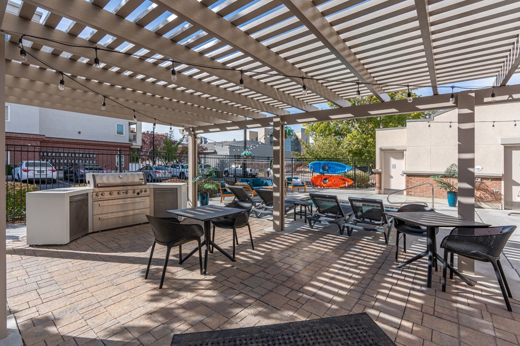 an outdoor patio with tables and chairs and a kitchenat The View on 20th, Ogden, UT