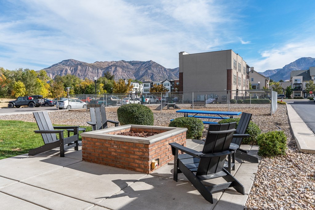 an outdoor patio with chairs and a fire pit with mountains in the backgroundat The View on 20th, Utah