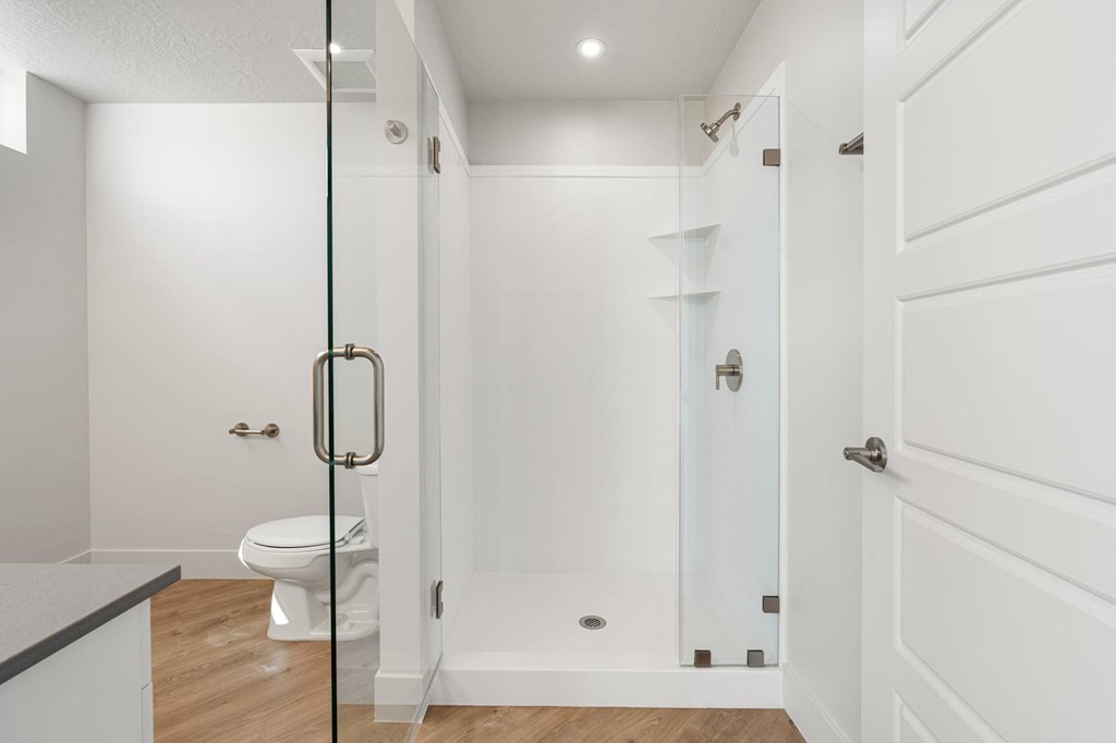 A white bathroom with a walk in shower and toilet. at The Vue At Desert Color, St. George, UT, 84790