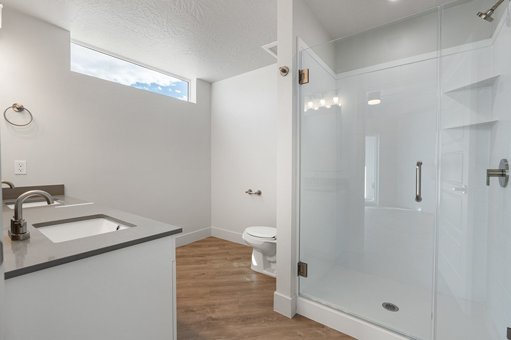 A white bathroom with a walk in shower. at The Vue At Desert Color, St. George, UT, 84790