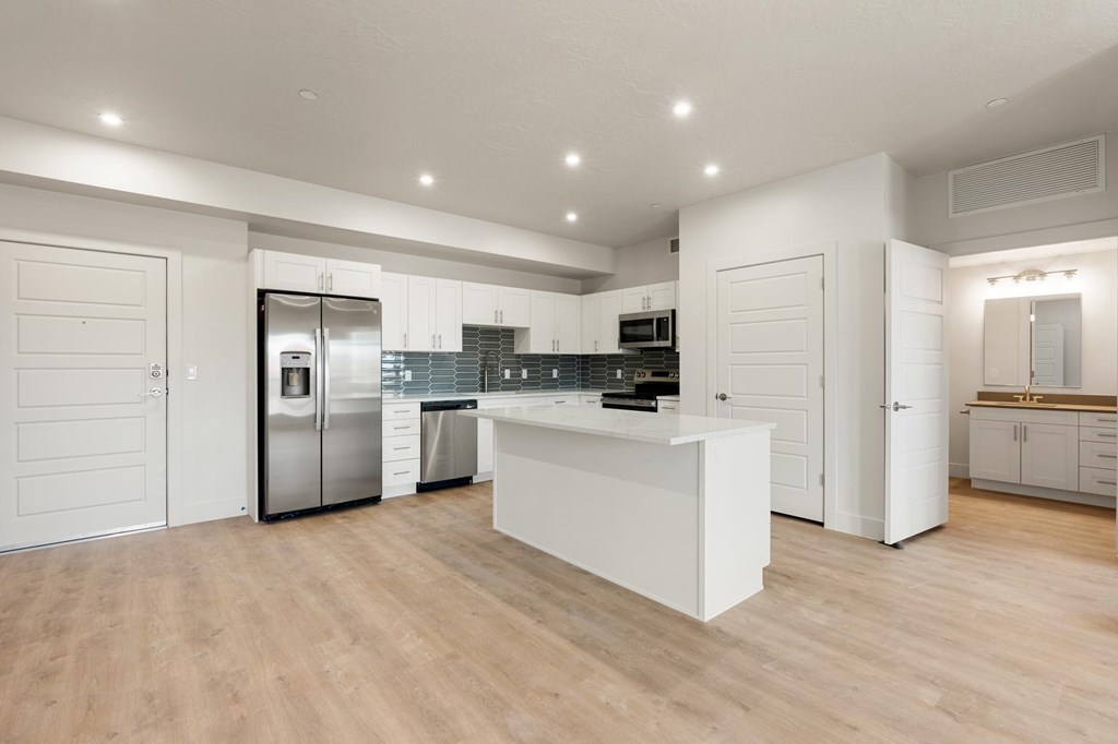 A modern kitchen with a white island and stainless steel appliances. at The Vue At Desert Color, Utah, 84790