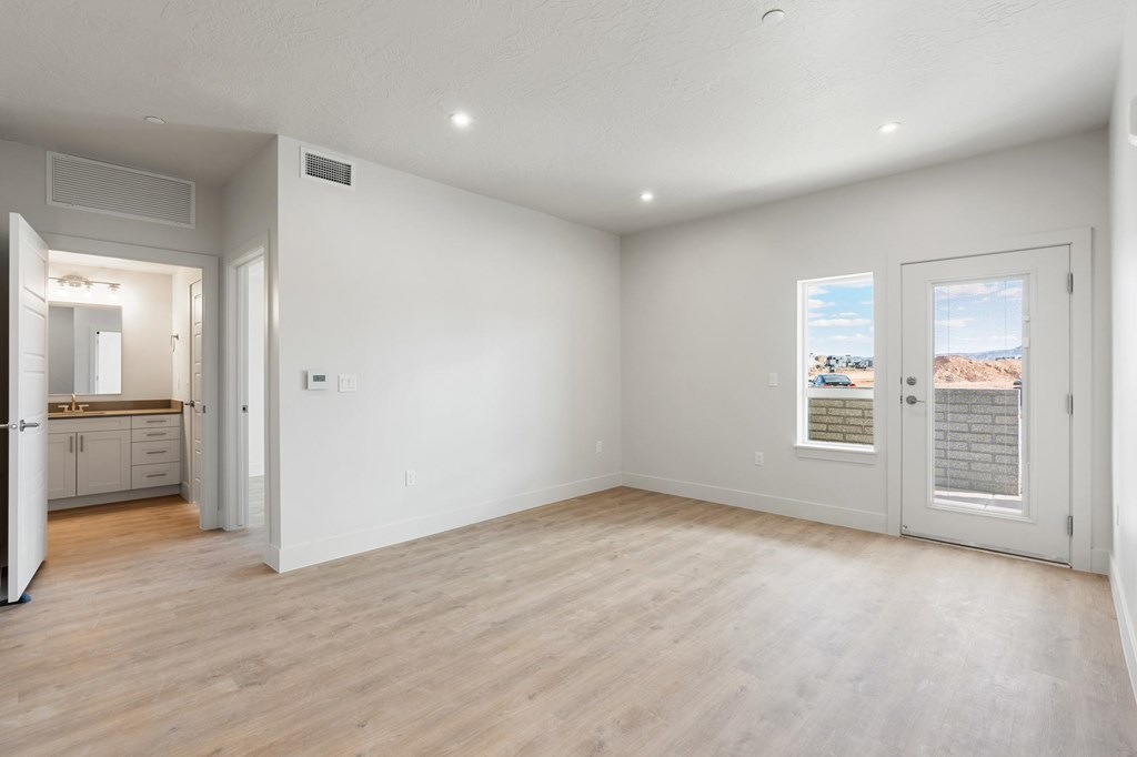 A large empty room with a view of the outside through the window. at The Vue At Desert Color, St. George, UT