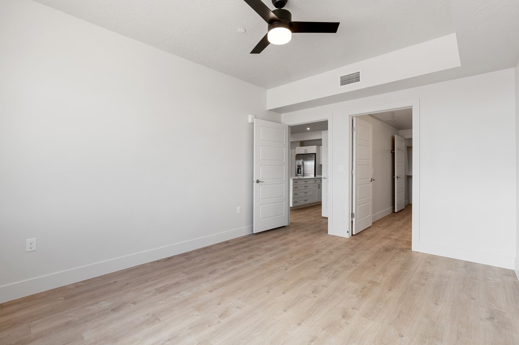 A room with a ceiling fan and light fixture. at The Vue At Desert Color, Utah, 84790