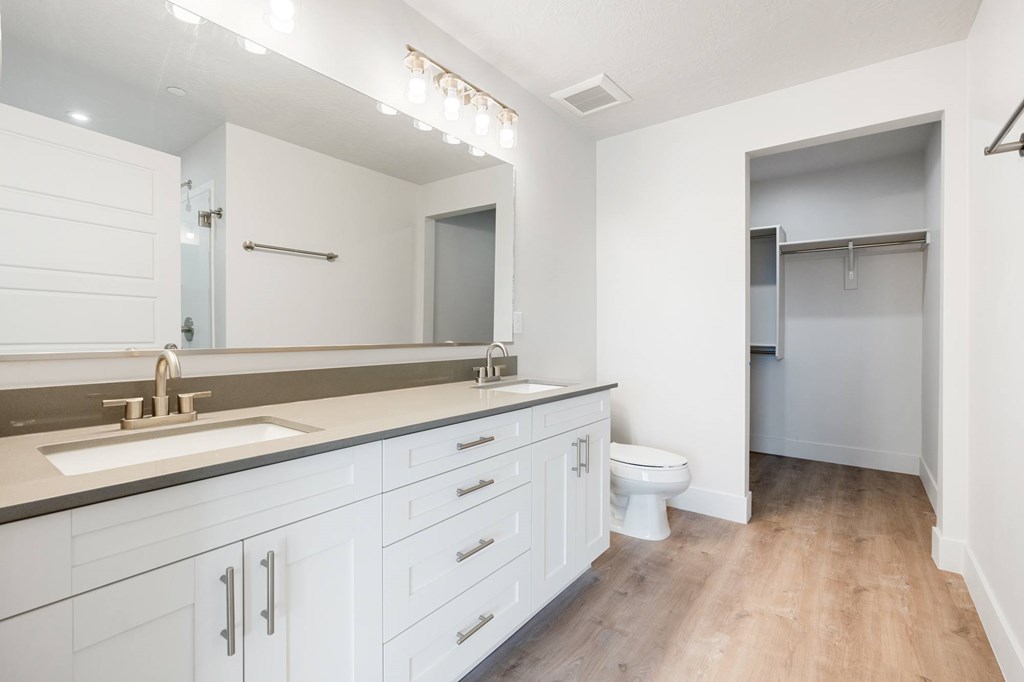 A white bathroom with a toilet and sink. at The Vue At Desert Color, St. George, UT