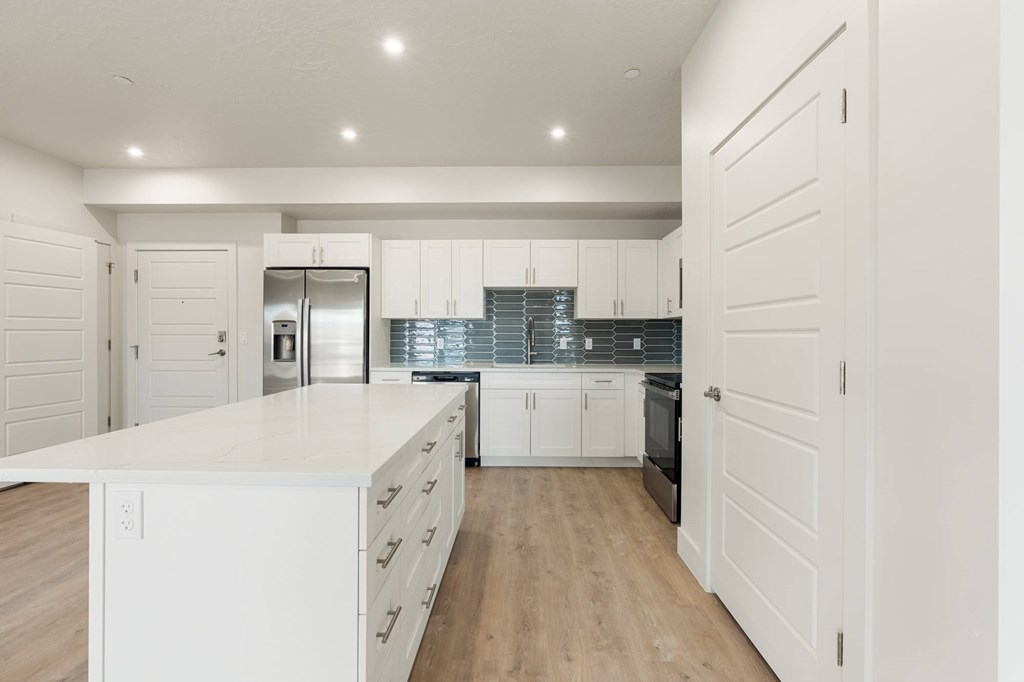A kitchen with white cabinets and a white counter top. at The Vue At Desert Color, St. George, UT
