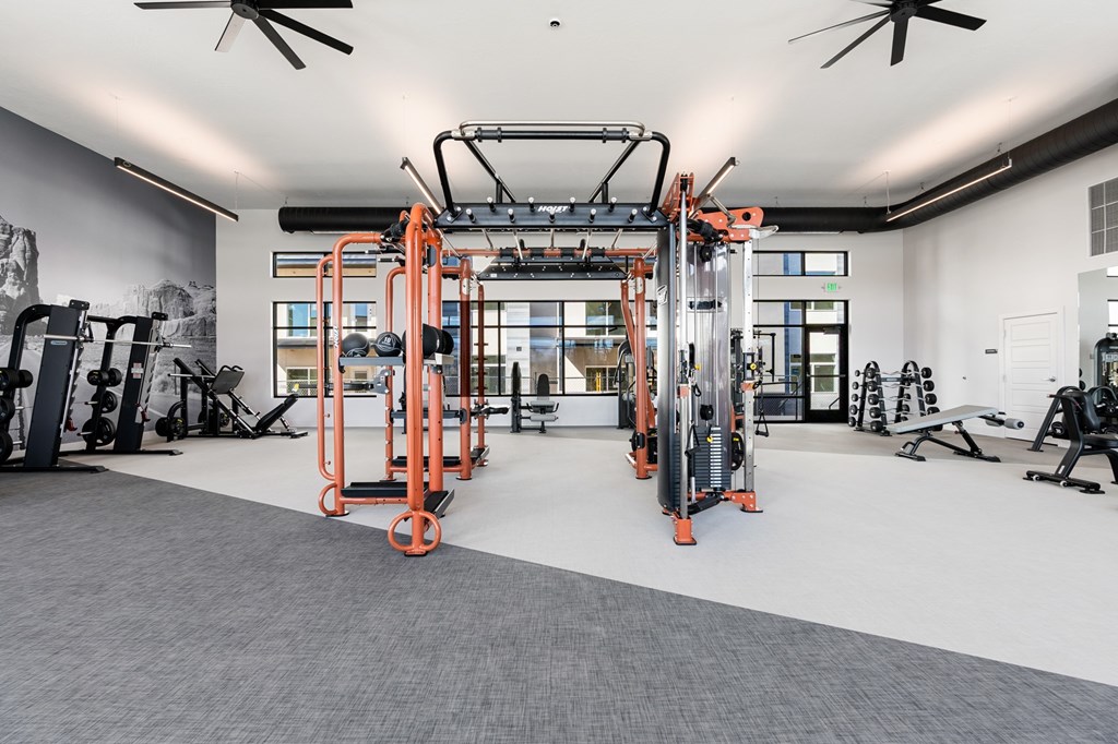 A gym with orange and black equipment. at The Vue At Desert Color, St. George, UT