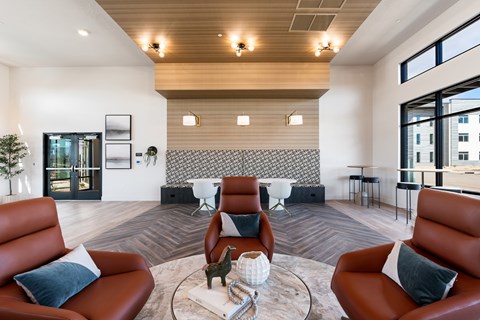 A living room with brown leather chairs and a white coffee table.