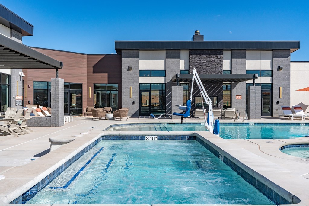 A swimming pool in front of a modern building. at The Vue At Desert Color, Utah, 84790