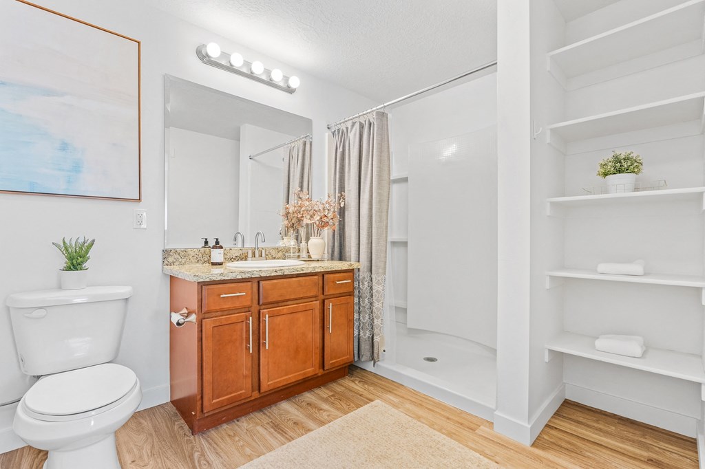 a bathroom with a toilet and a sink and a mirrorat The View on 20th, Ogden