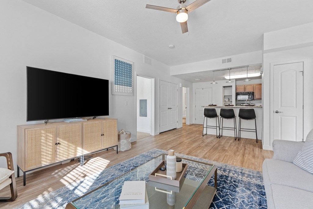 a living room with a tv and a kitchen in the backgroundat The View on 20th, Ogden, 84401
