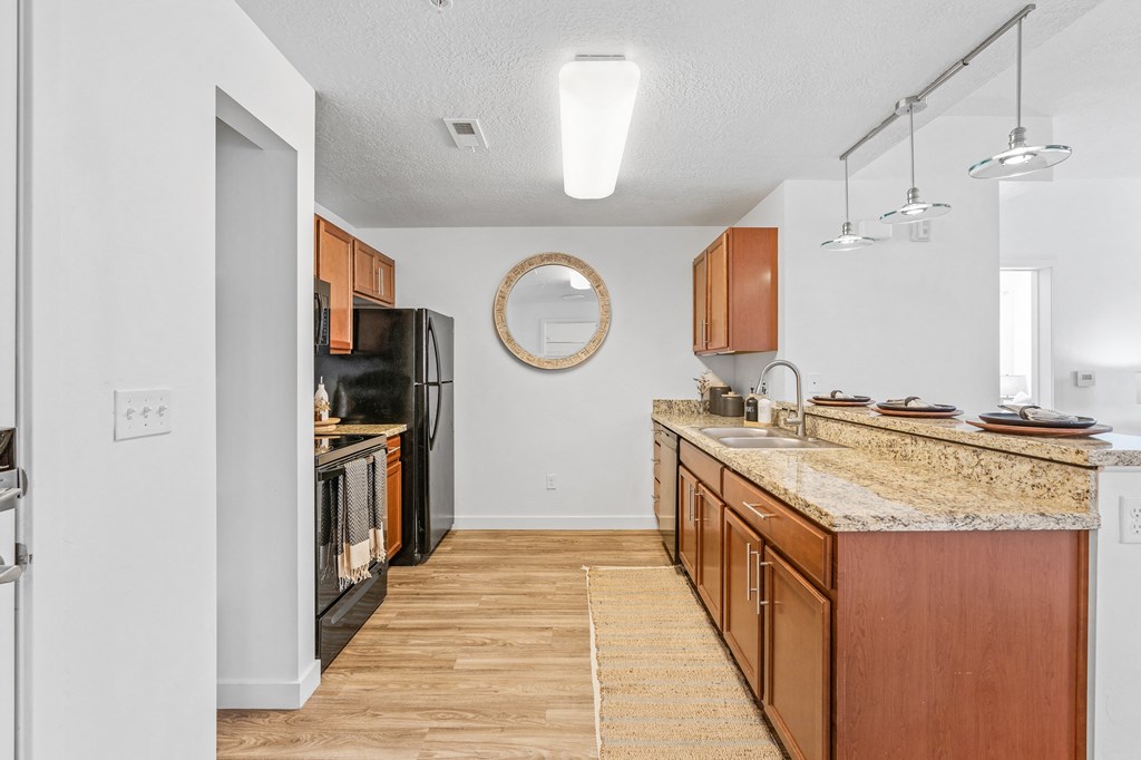a spacious kitchen with granite counter tops and wooden cabinetsat The View on 20th, Ogden, UT, 84401