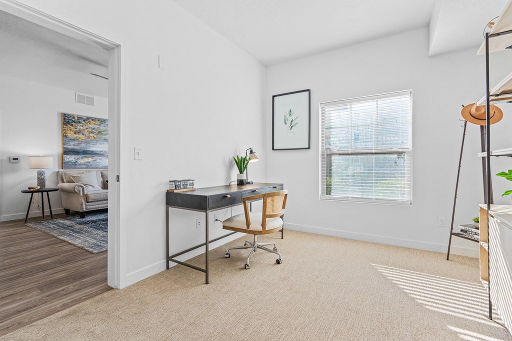an office space with a desk and a mirror and a windowat The View on 20th, Ogden, UT