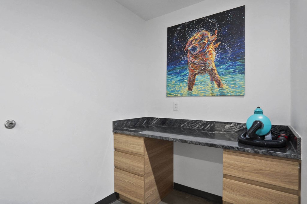 a painting of a dog on the wall of a bathroom at The Flats at Riverwoods, Utah, 84604