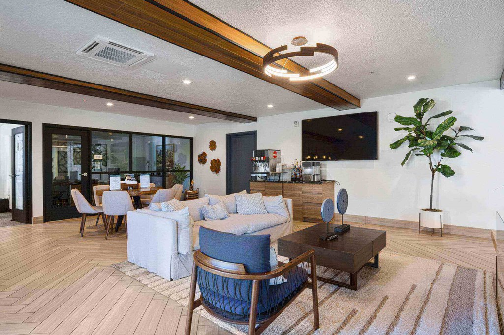 a living room filled with furniture and a large window at The Flats at Riverwoods, Provo, Utah