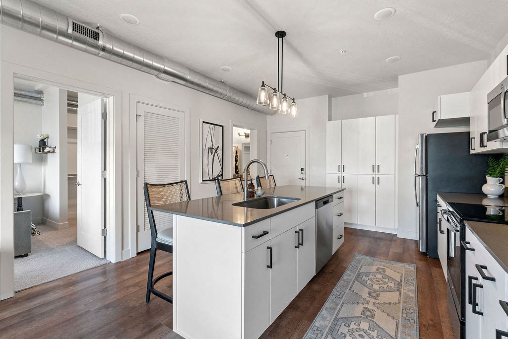 an open kitchen and dining area with a large counter top at The Revival, Salt Lake City Utah