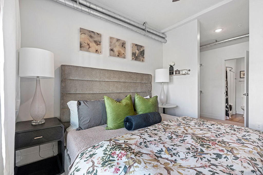 a bedroom with a bed and some pillows at The Revival, Salt Lake City