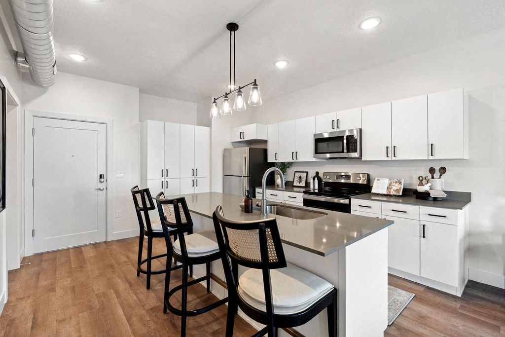an open kitchen with an island with four chairs at The Revival, Salt Lake City, 84101
