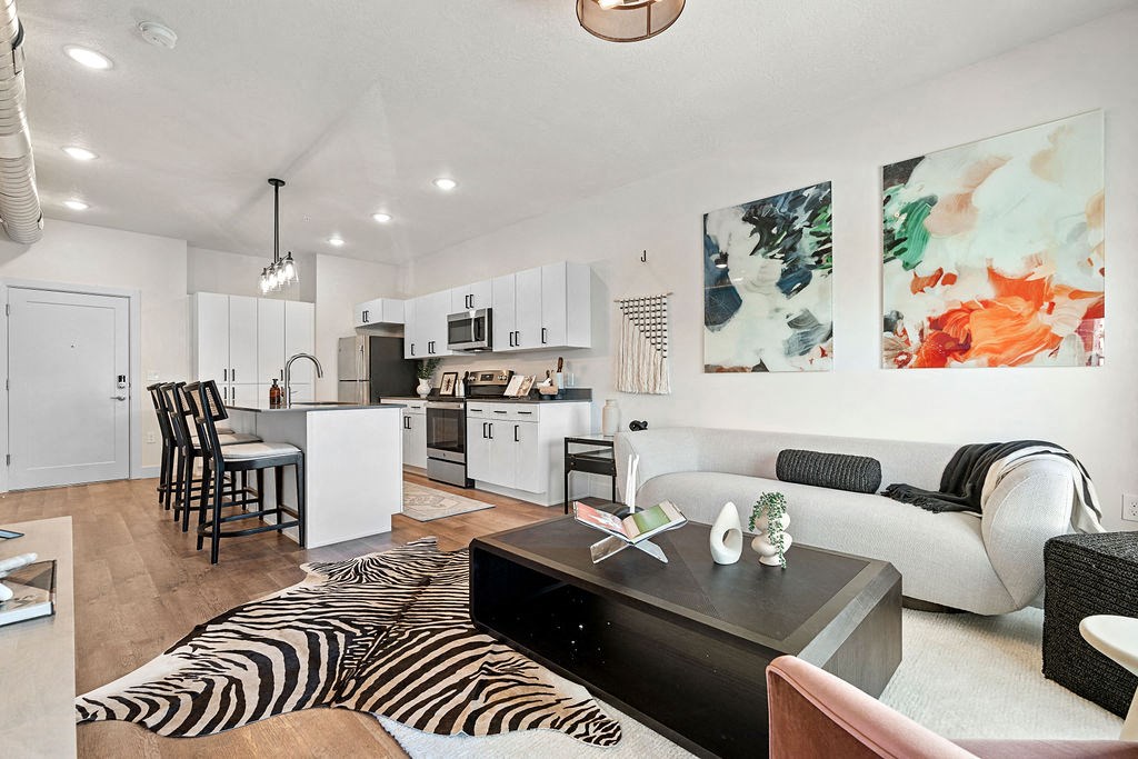 an open living room and kitchen with a zebra rug at The Revival, Salt Lake City, UT 84101