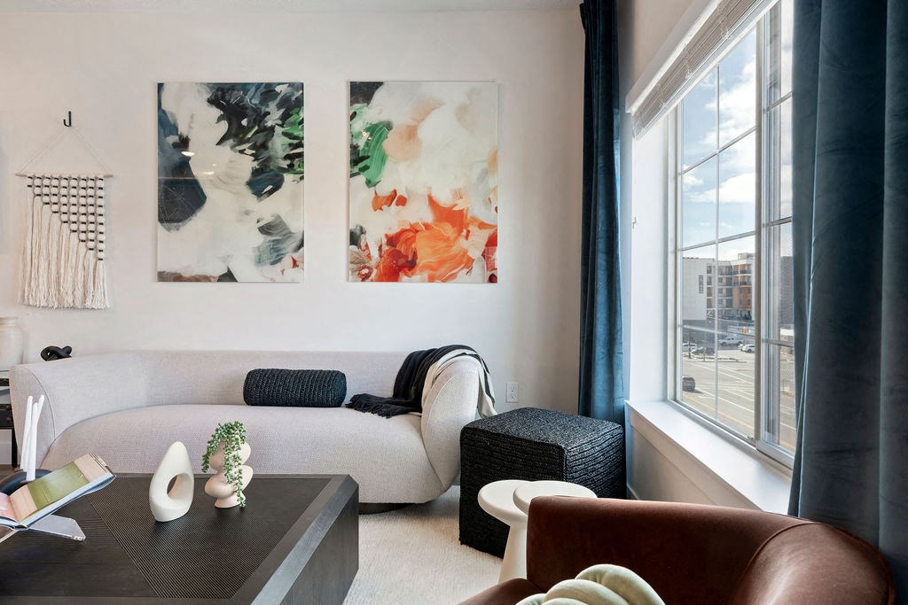 a living room with a white couch and two paintings on the wall at The Revival, Utah