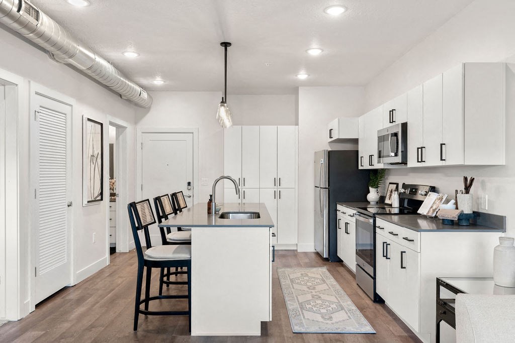 an open kitchen and dining area with a table and chairs at The Revival, Utah