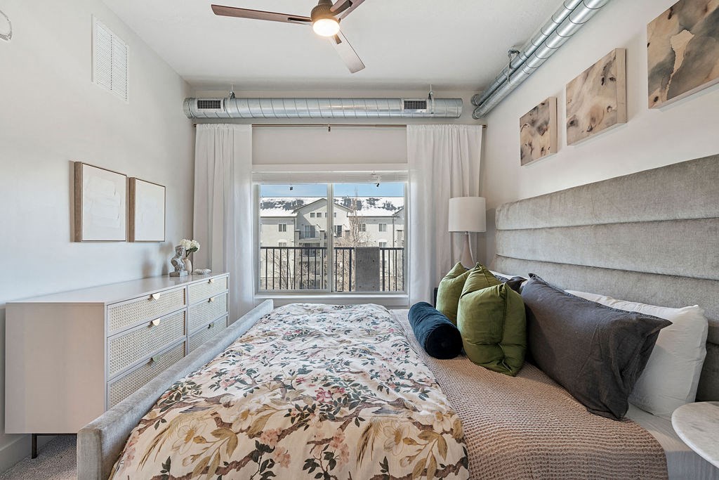 a bedroom with a large bed and a window at The Revival, Utah, 84101