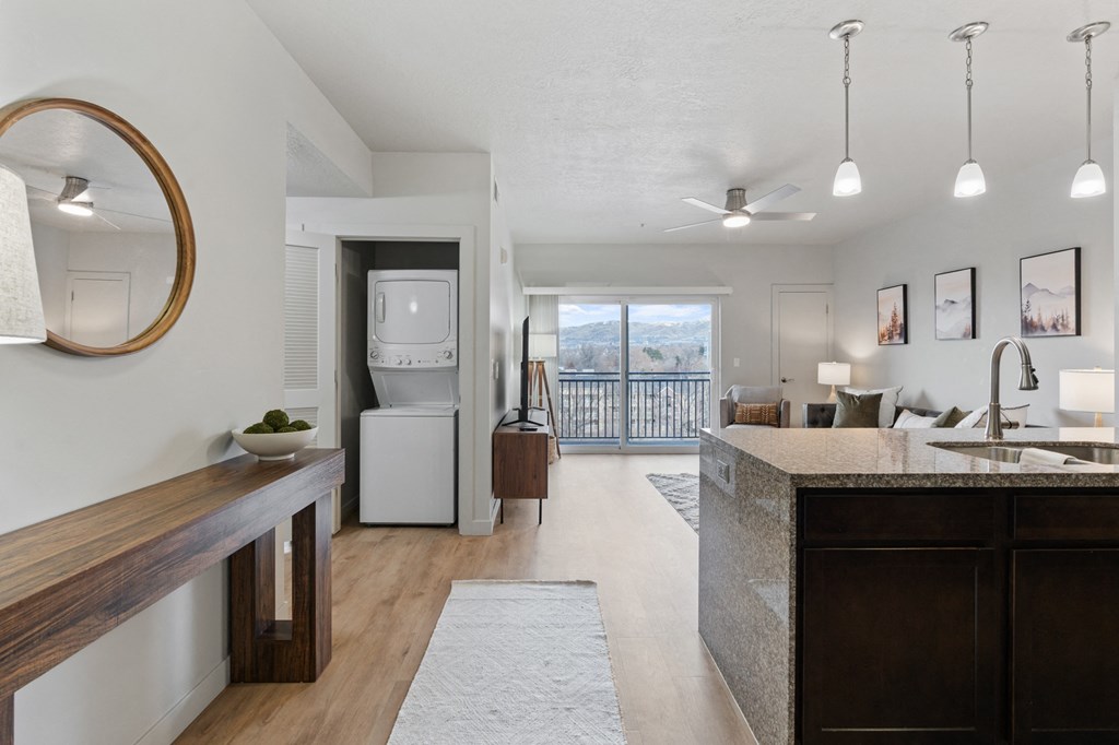 A modern kitchen with a large island and a view of the outdoors. at Wilmington Flats Apartments, Salt Lake City, UT