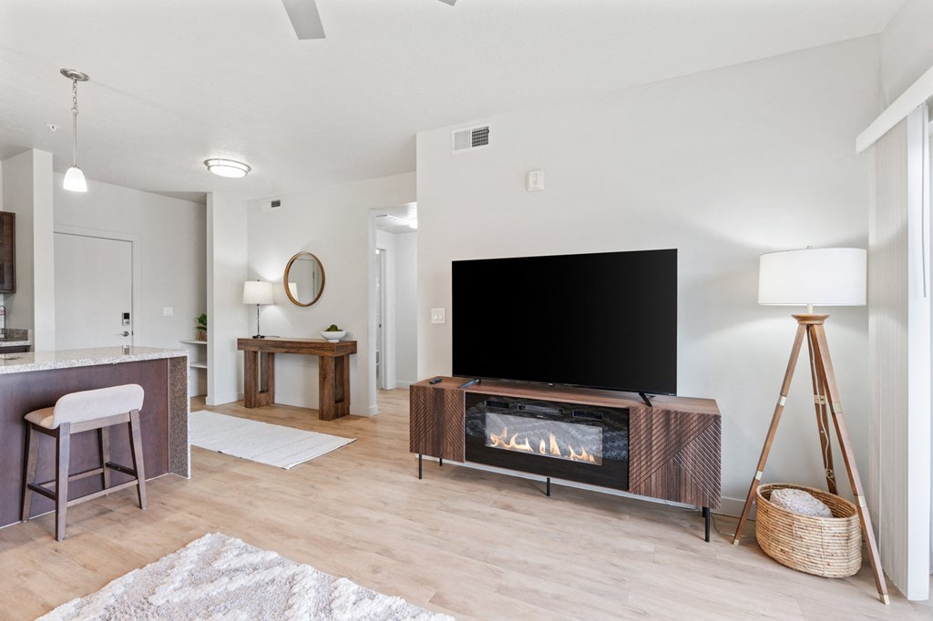 A modern living room with a flat screen TV and a fireplace at Wilmington Flats Apartments, Salt Lake City, 84106
