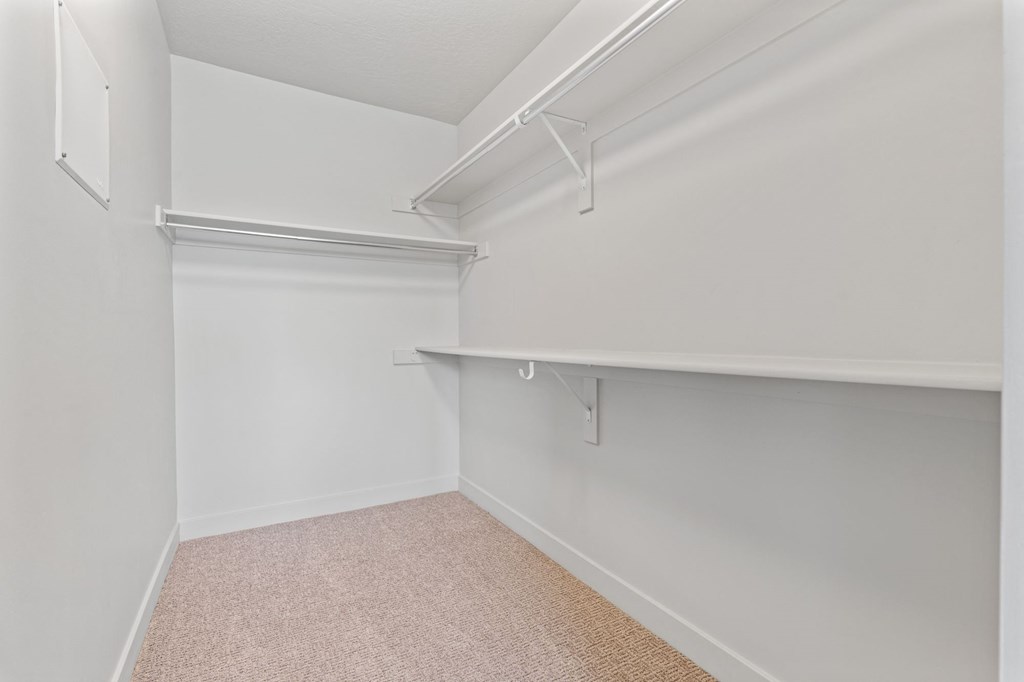A white closet with a carpeted floor and a white shelf at Wilmington Flats Apartments, Salt Lake City
