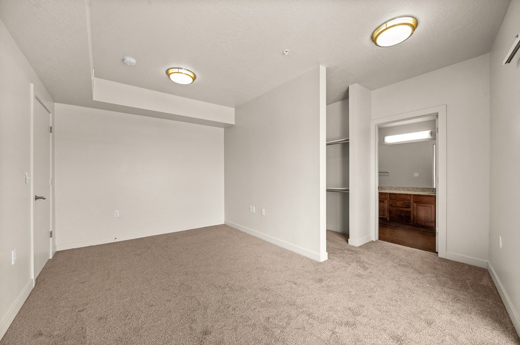 a bedroom with gray carpet and white walls