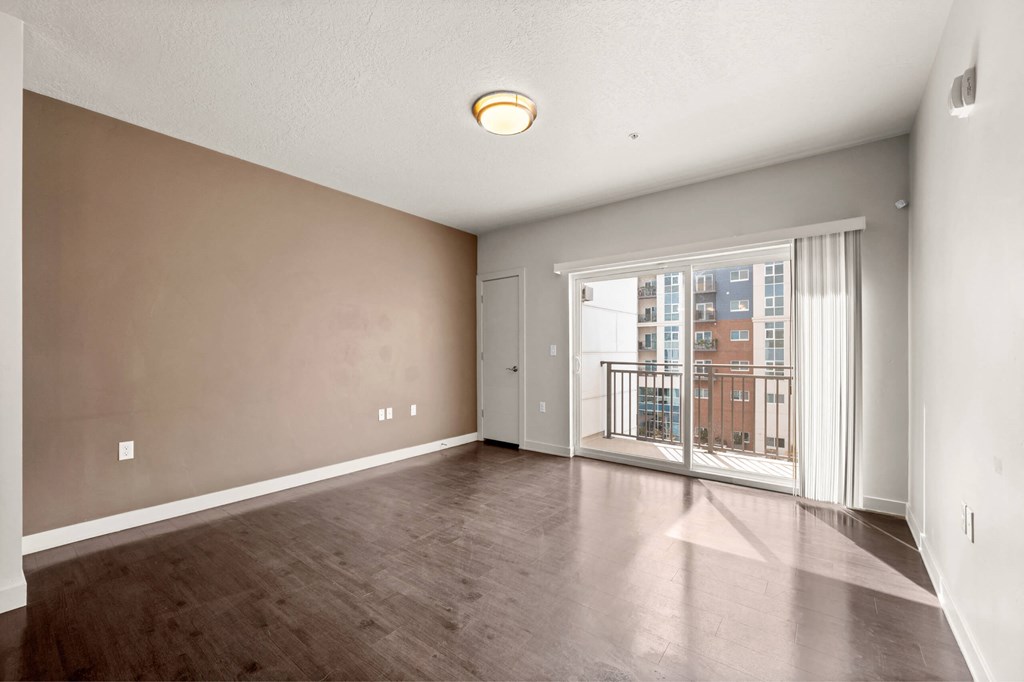 a bedroom with hardwood flooring and a balcony at Wilmington Flats Apartments, Salt Lake City, 84106