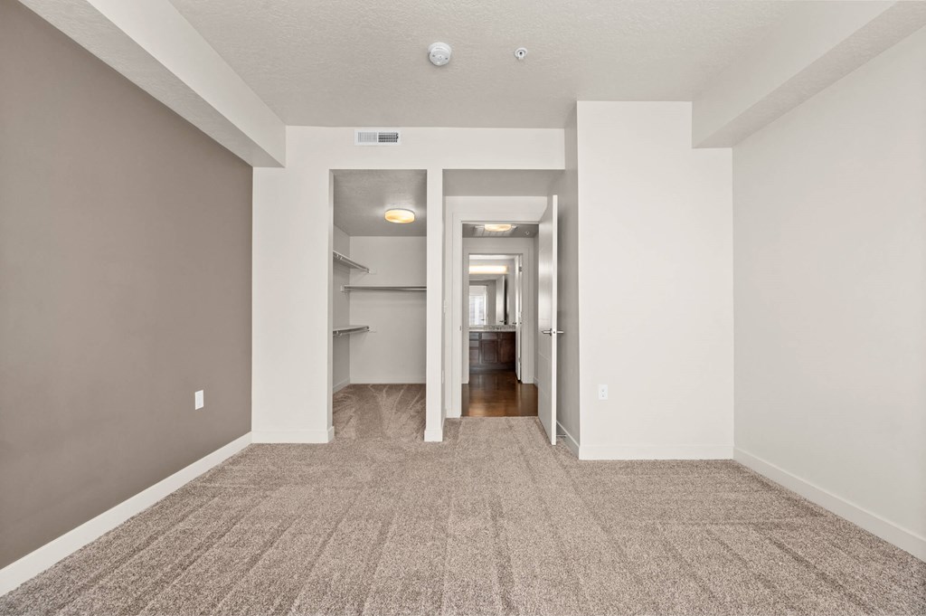 a spacious living room with gray walls and a carpeted floor at Wilmington Flats Apartments, Salt Lake City