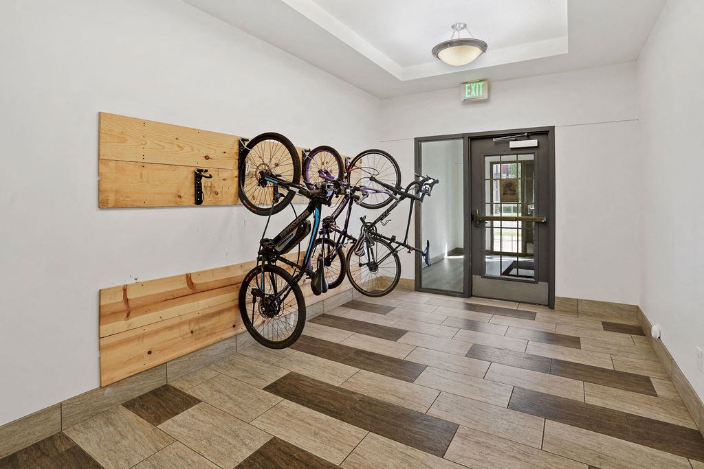 a bike rack with three bikes on the wall at The View on 20th, Ogden, UT, 84401