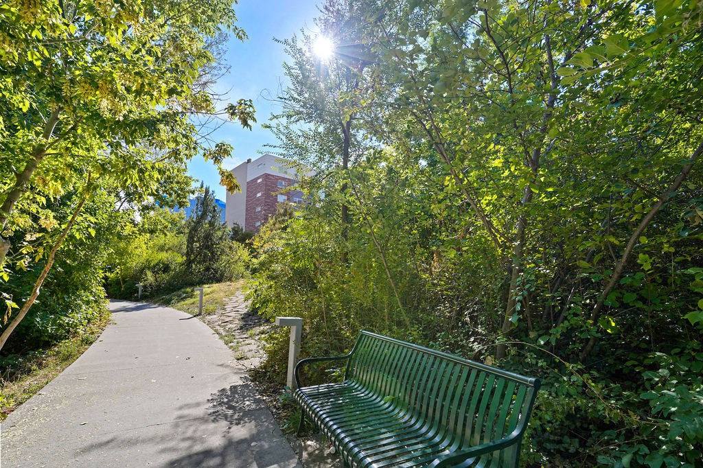 a green park bench sitting next to a sidewalk at Wilmington Flats Apartments, Salt Lake City, Utah
