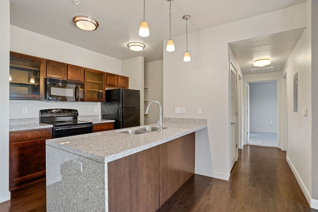 a kitchen with an island with a sink and a stove at Wilmington Flats Apartments, Salt Lake City, UT